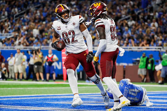 Washington Commanders tight end Logan Thomas (82) and receiver Cam Sims (89) celebrate a play against the Detroit Lions.